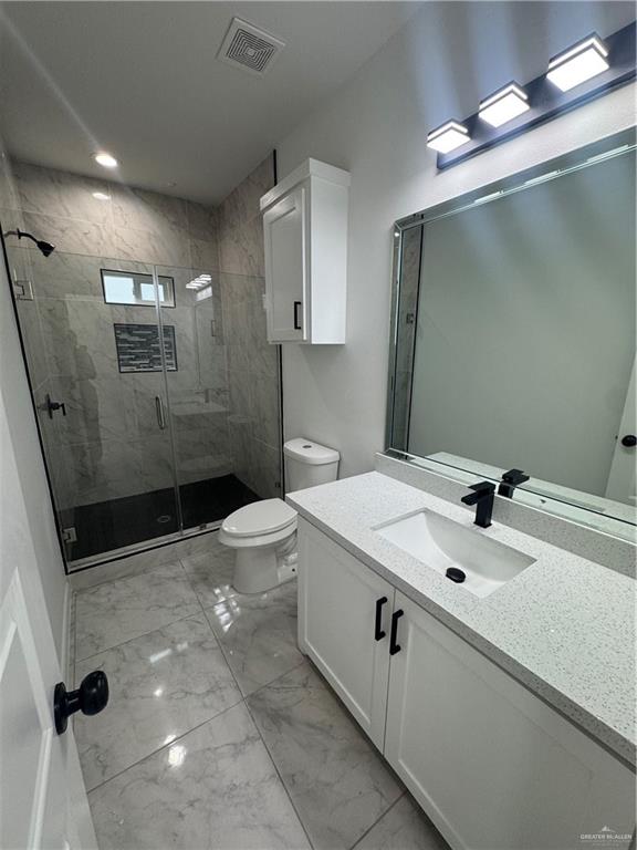 5804 Notre Dame Avenue, Unit 3 Mission, TX 78573 - Photo 5 of 12 a bathroom with a sink a toilet a mirror and shower