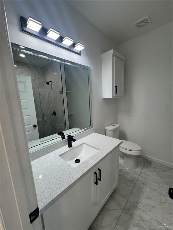 5804 Notre Dame Avenue, Unit 3 Mission, TX 78573 - Photo 9 of 12 a bathroom with a sink a toilet and mirror