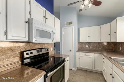 a kitchen with cabinets a sink and appliances