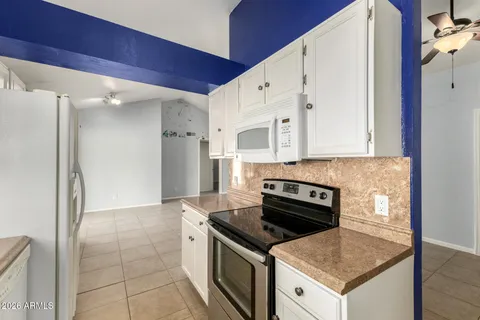 a kitchen with a stove and a refrigerator