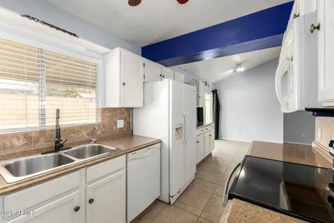 a view of an empty room with a kitchen