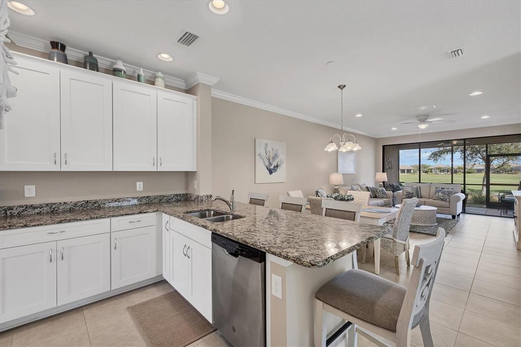 13703 Messina Loop, Unit 104 Bradenton, FL 34211 - Photo 15 of 86 a kitchen with center island table and chairs