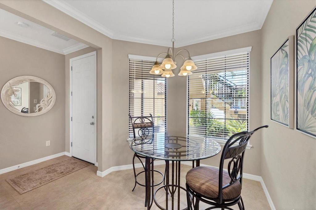 13703 Messina Loop, Unit 104 Bradenton, FL 34211 - Photo 20 of 86 a view of a dining room with furniture window and chandelier