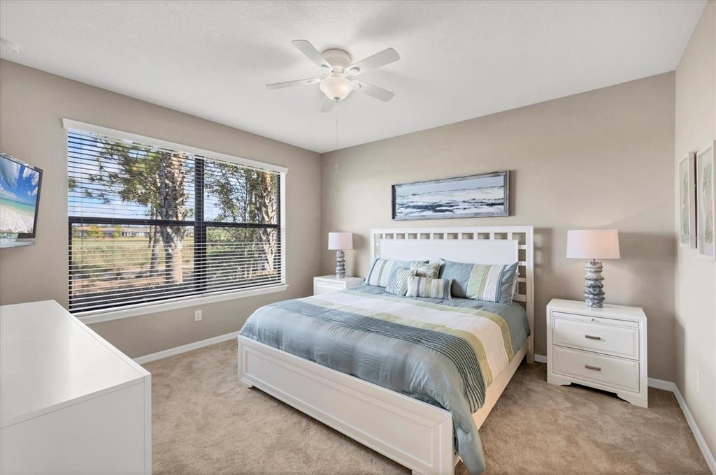 13703 Messina Loop, Unit 104 Bradenton, FL 34211 - Photo 21 of 86 a bedroom with a large bed and a large window