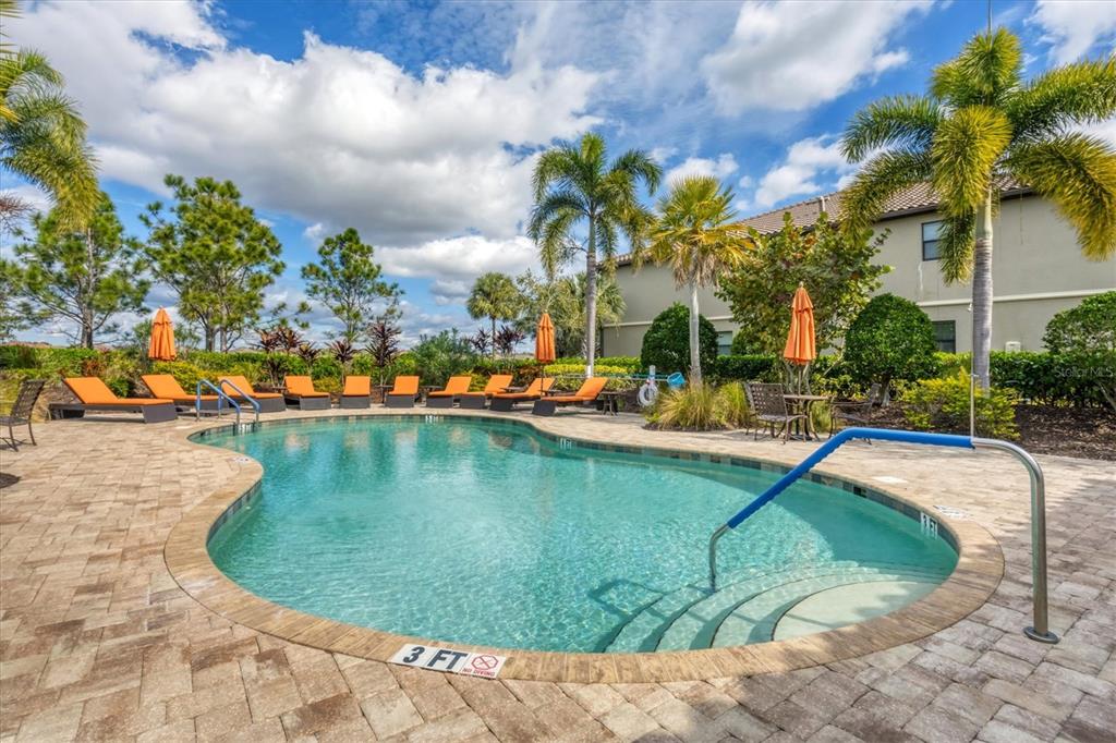 13703 Messina Loop, Unit 104 Bradenton, FL 34211 - Photo 37 of 86 a view of a swimming pool with a lawn chairs