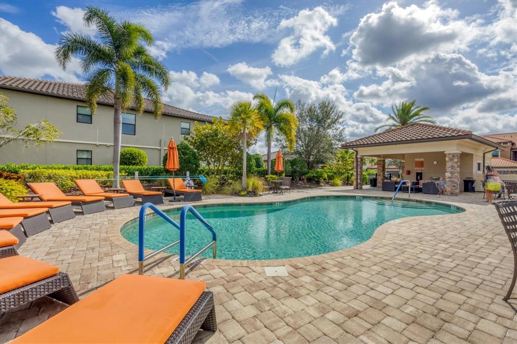 13703 Messina Loop, Unit 104 Bradenton, FL 34211 - Photo 38 of 86 a swimming pool with outdoor seating and yard