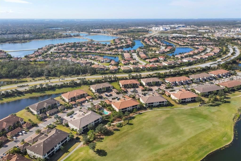 13703 Messina Loop, Unit 104 Bradenton, FL 34211 - Photo 79 of 86 an aerial view of residential houses with outdoor space