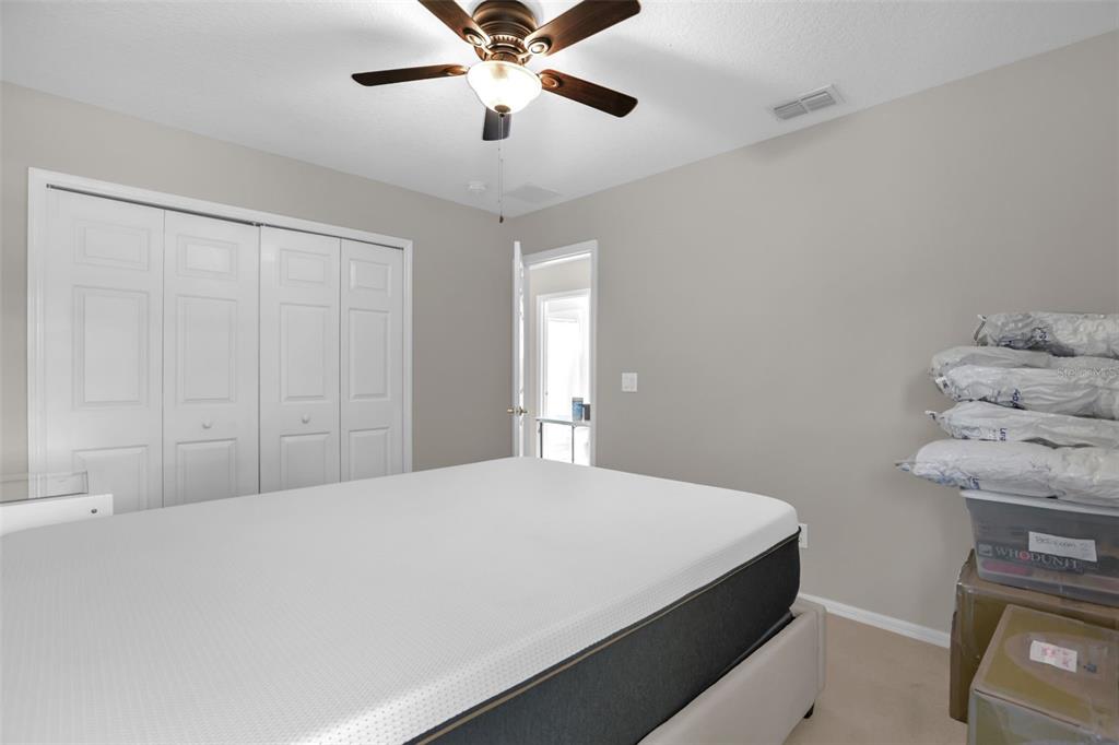 2165 Ridgewood Street Orlando, FL 32803 - Photo 25 of 37 a bedroom with a bed and a ceiling fan