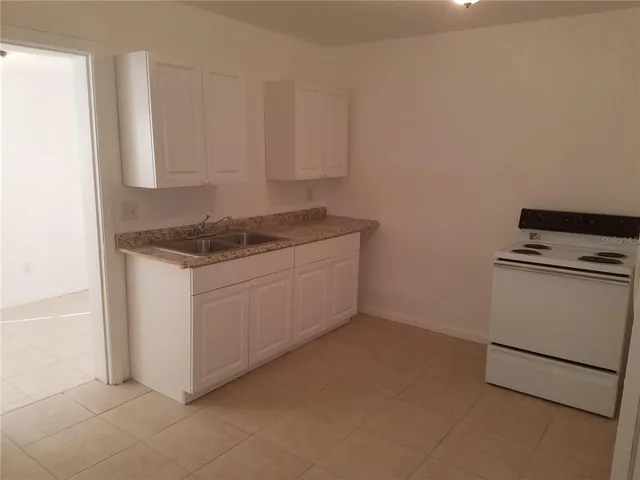 a white toilet sitting next to a bath tub