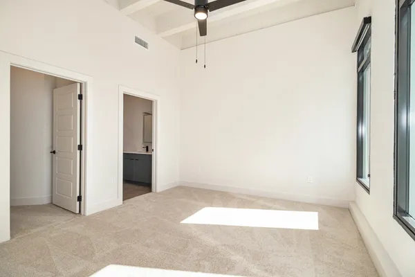 a view of a room with wooden floor and white walls