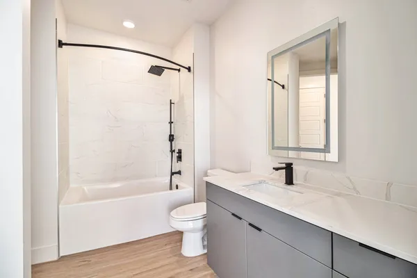 a bathroom with a sink toilet and shower