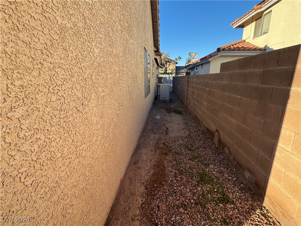 7447 Palermo Avenue Las Vegas, NV 89147 - Photo 21 of 26 View of side of home with stucco siding and a tile roof