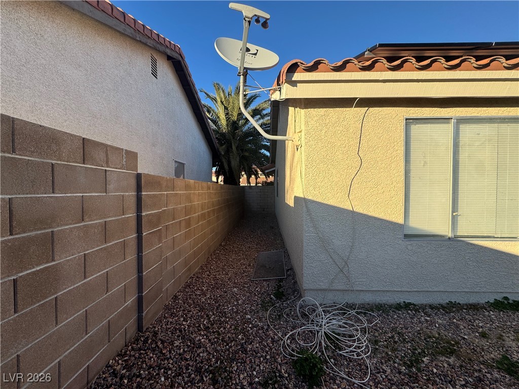 7447 Palermo Avenue Las Vegas, NV 89147 - Photo 22 of 26 View of side of property with a tile roof and stucco siding