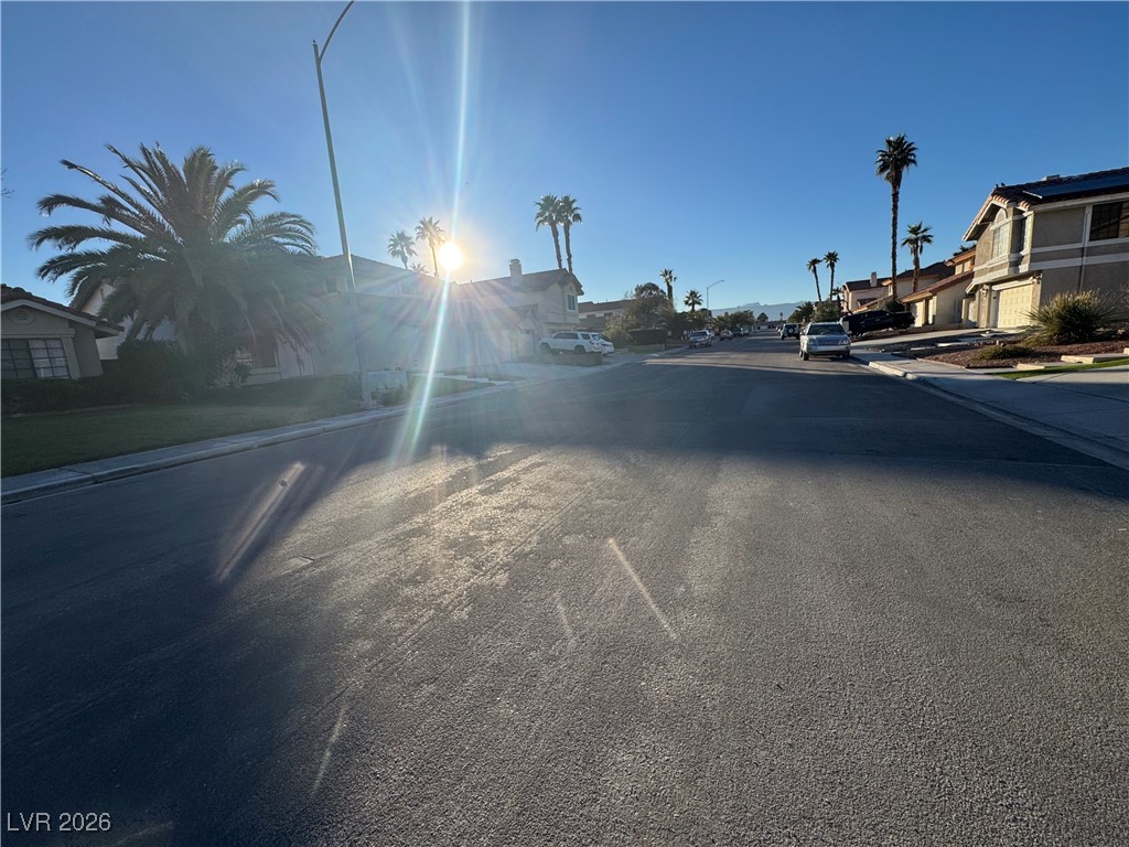 7447 Palermo Avenue Las Vegas, NV 89147 - Photo 24 of 26 View of asphalt road with sidewalks, street lighting, and curbs