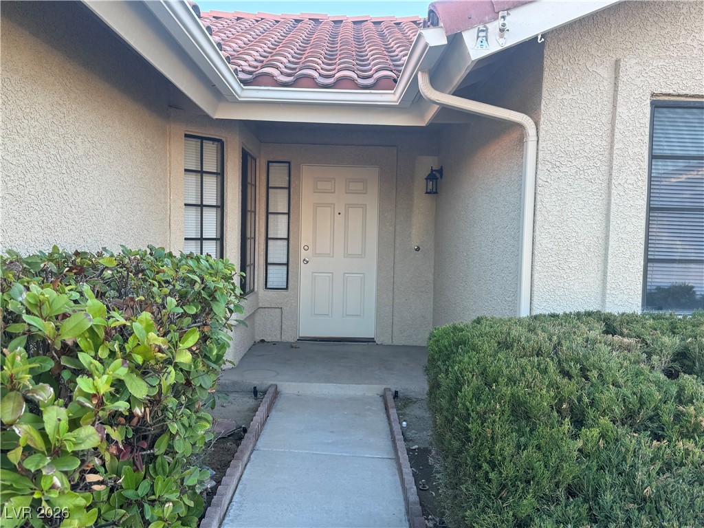 7447 Palermo Avenue Las Vegas, NV 89147 - Photo 3 of 26 Doorway to property featuring stucco siding