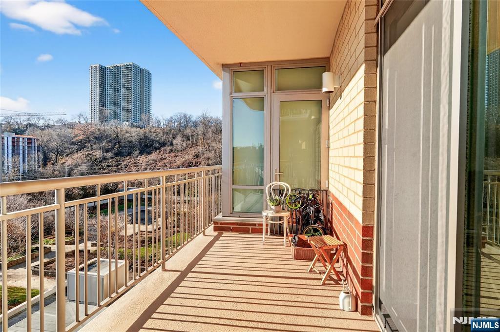 8100 River Road, Unit 801 North Bergen, NJ 07047 - Photo 12 of 48 a balcony with wooden floor and furniture
