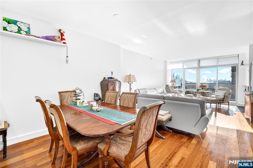 8100 River Road, Unit 801 North Bergen, NJ 07047 - Photo 18 of 48 a dining room with a wooden table and chairs
