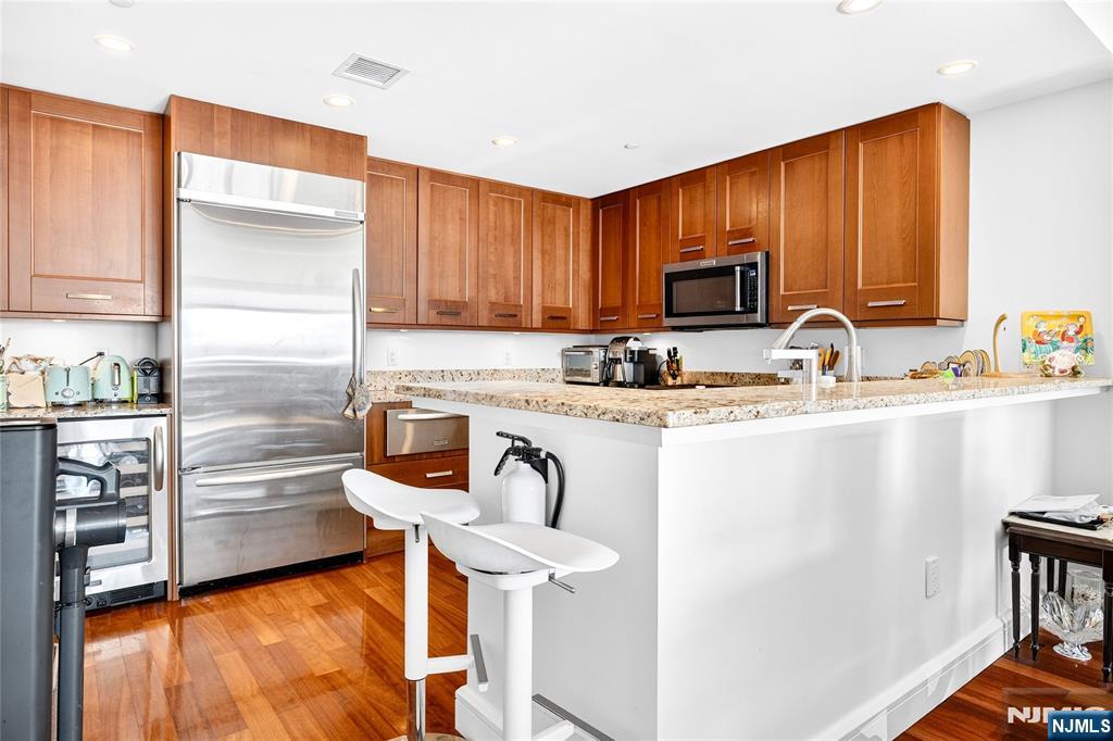 8100 River Road, Unit 801 North Bergen, NJ 07047 - Photo 19 of 48 a kitchen with granite countertop a refrigerator and a stove top oven