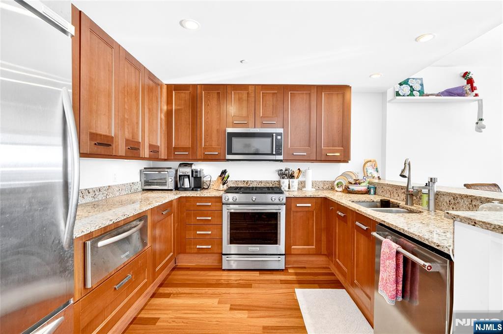 8100 River Road, Unit 801 North Bergen, NJ 07047 - Photo 21 of 48 a kitchen with stainless steel appliances granite countertop a stove a sink and a microwave