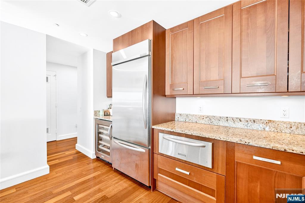8100 River Road, Unit 801 North Bergen, NJ 07047 - Photo 25 of 48 a kitchen with granite countertop a refrigerator and cabinets