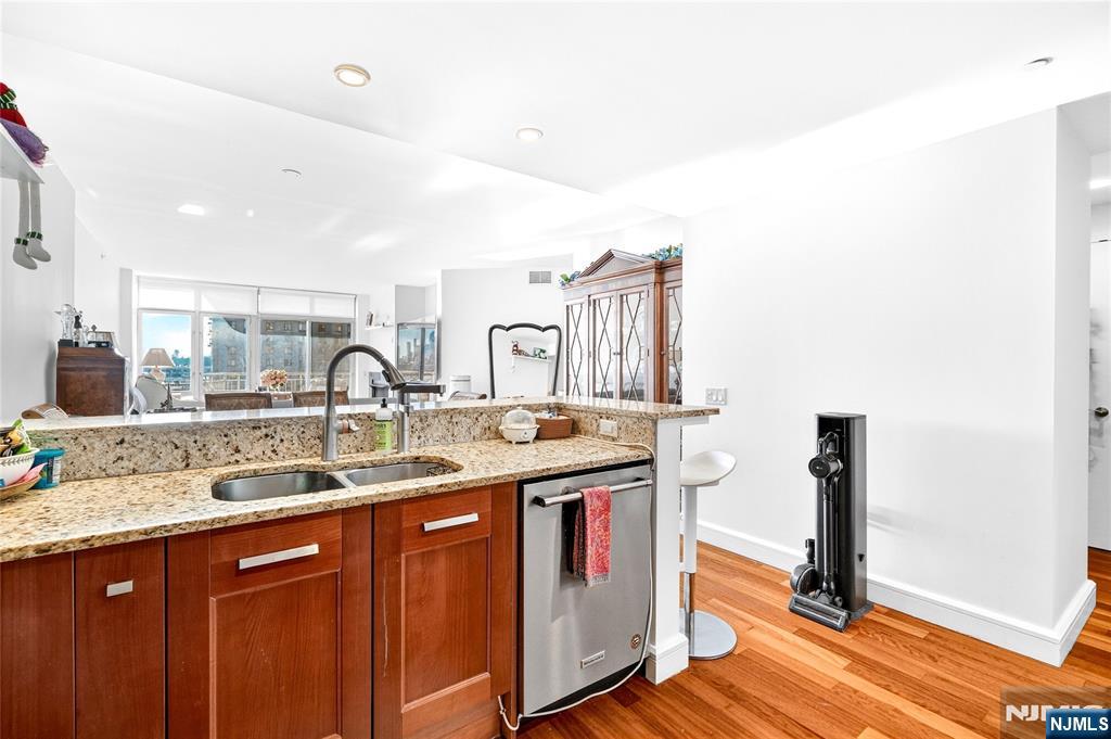 8100 River Road, Unit 801 North Bergen, NJ 07047 - Photo 26 of 48 a kitchen with stainless steel appliances granite countertop a sink stove and cabinets