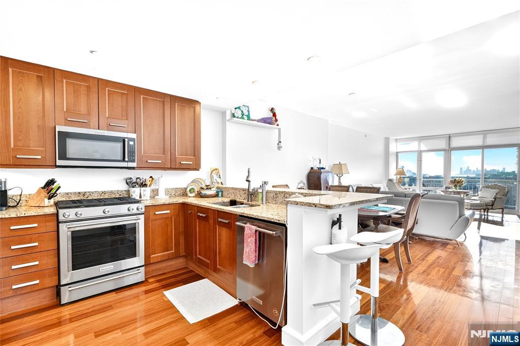 8100 River Road, Unit 801 North Bergen, NJ 07047 - Photo 27 of 48 a kitchen with a stove top oven and cabinets