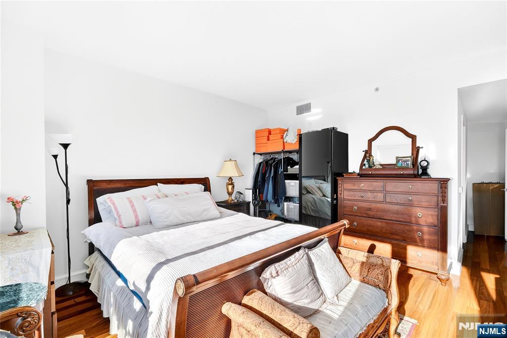 8100 River Road, Unit 801 North Bergen, NJ 07047 - Photo 29 of 48 a bed sitting in a bedroom and mirror