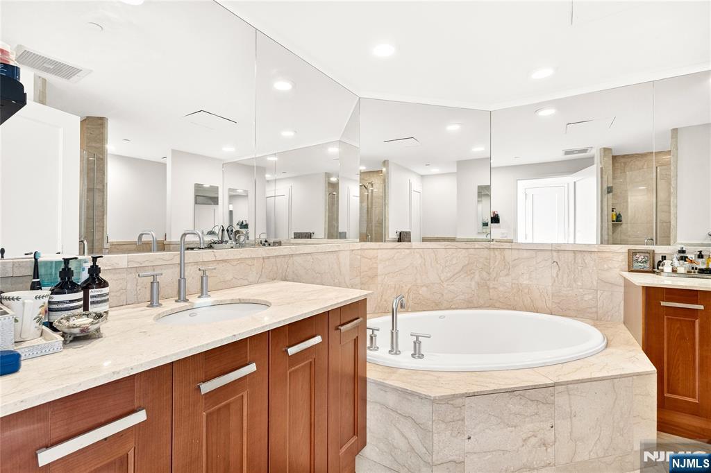 8100 River Road, Unit 801 North Bergen, NJ 07047 - Photo 33 of 48 a bathroom with a tub sink and mirror