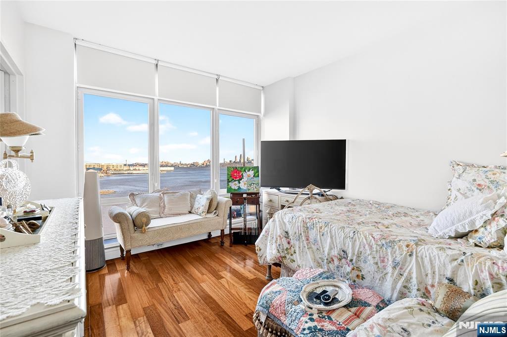 8100 River Road, Unit 801 North Bergen, NJ 07047 - Photo 38 of 48 a bedroom with furniture and a flat screen tv