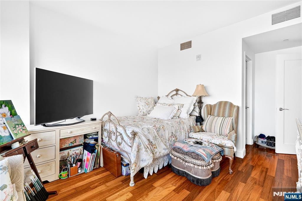 8100 River Road, Unit 801 North Bergen, NJ 07047 - Photo 40 of 48 a bedroom with furniture and a flat screen tv