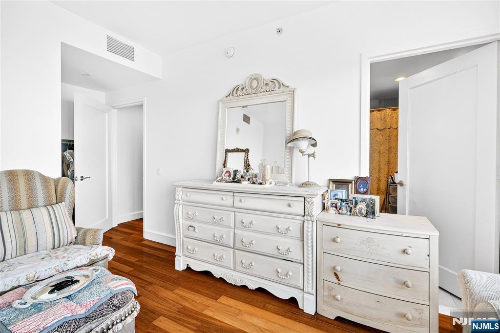 8100 River Road, Unit 801 North Bergen, NJ 07047 - Photo 41 of 48 a bedroom with a bed and a dresser in it
