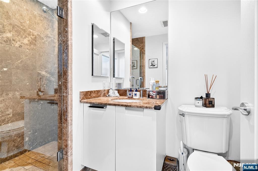 8100 River Road, Unit 801 North Bergen, NJ 07047 - Photo 43 of 48 a bathroom with a sink toilet and shower