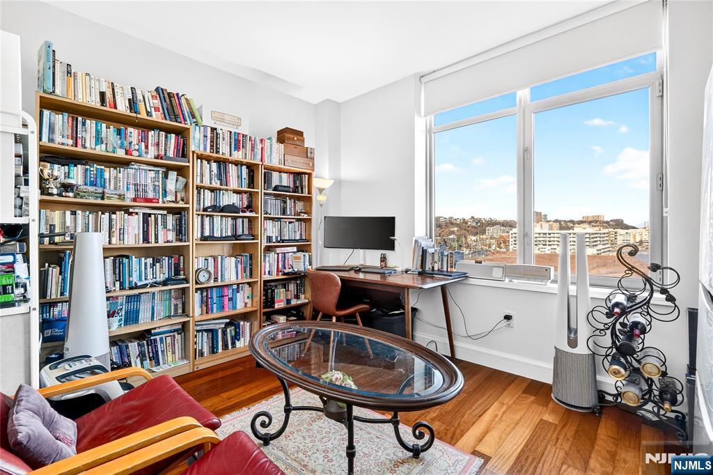 8100 River Road, Unit 801 North Bergen, NJ 07047 - Photo 45 of 48 a living room with furniture a bookshelf and a window