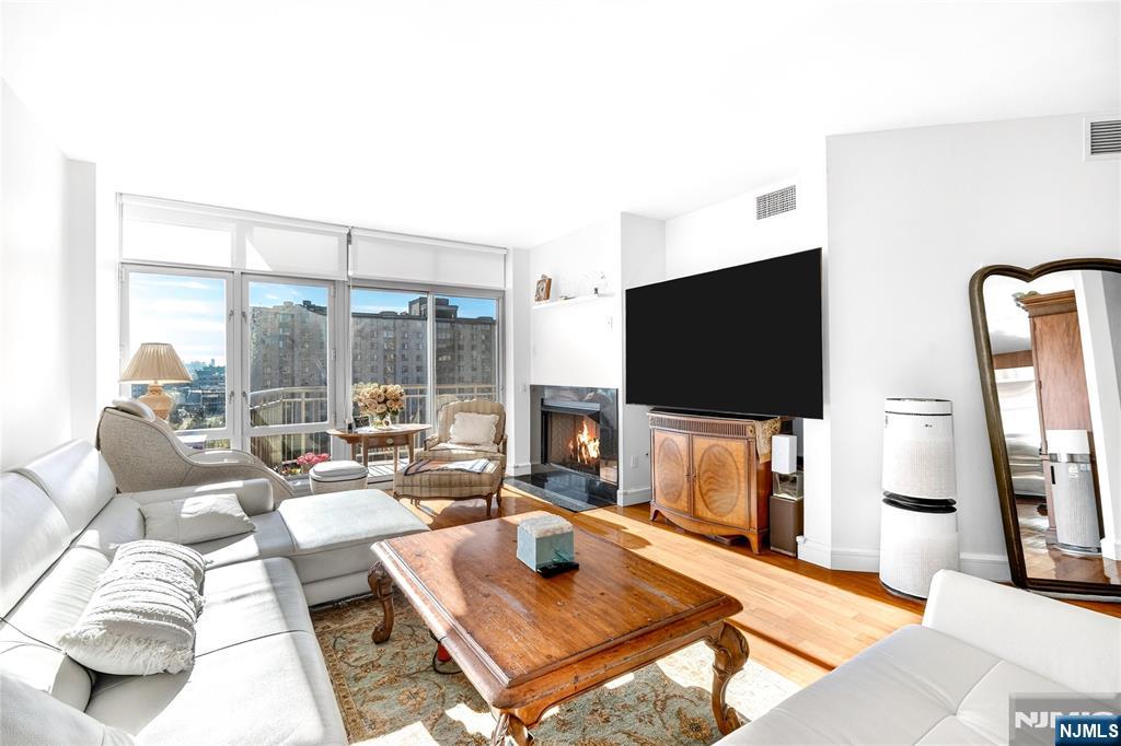 8100 River Road, Unit 801 North Bergen, NJ 07047 - Photo 9 of 48 a living room with furniture and a flat screen tv