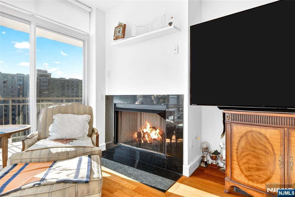 8100 River Road, Unit 801 North Bergen, NJ 07047 - Photo 10 of 48 a living room with furniture and a fireplace