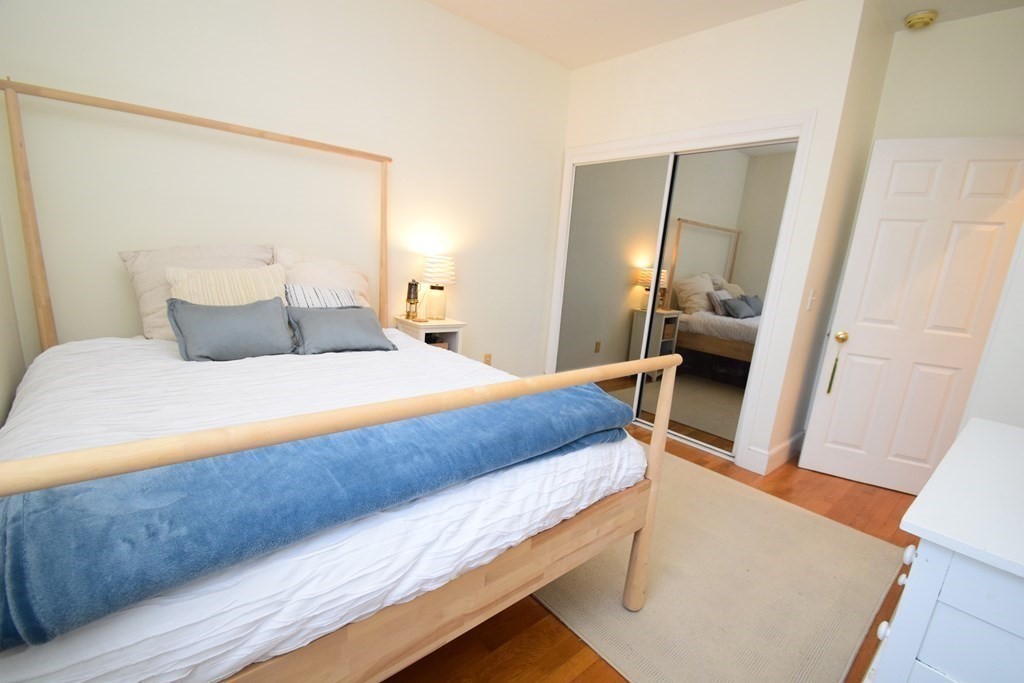 20 Concord Square, Unit 2 Boston, MA 02118 - Photo 11 of 16 a bedroom with a bed and a mirror