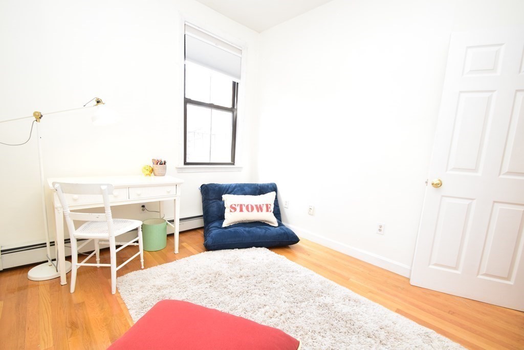 20 Concord Square, Unit 2 Boston, MA 02118 - Photo 14 of 16 a bedroom with a bed and a chair