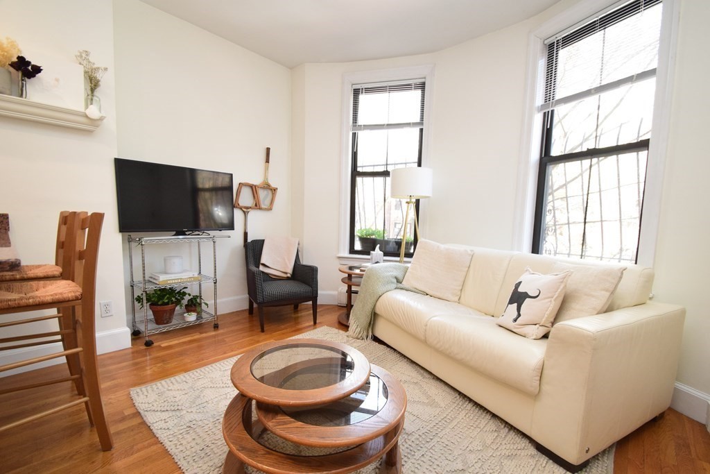 20 Concord Square, Unit 2 Boston, MA 02118 - Photo 2 of 16 a living room with furniture a flat screen tv and a large window