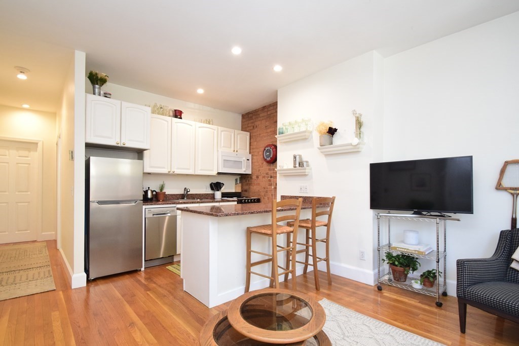 20 Concord Square, Unit 2 Boston, MA 02118 - Photo 6 of 16 a kitchen with a microwave a stove a sink and a refrigerator