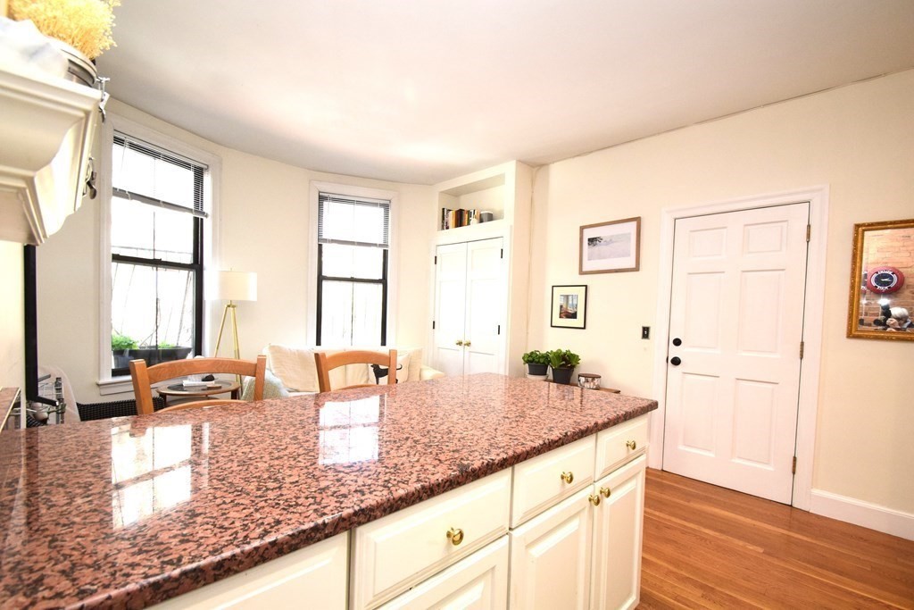 20 Concord Square, Unit 2 Boston, MA 02118 - Photo 9 of 16 a kitchen with granite countertop a sink and a refrigerator