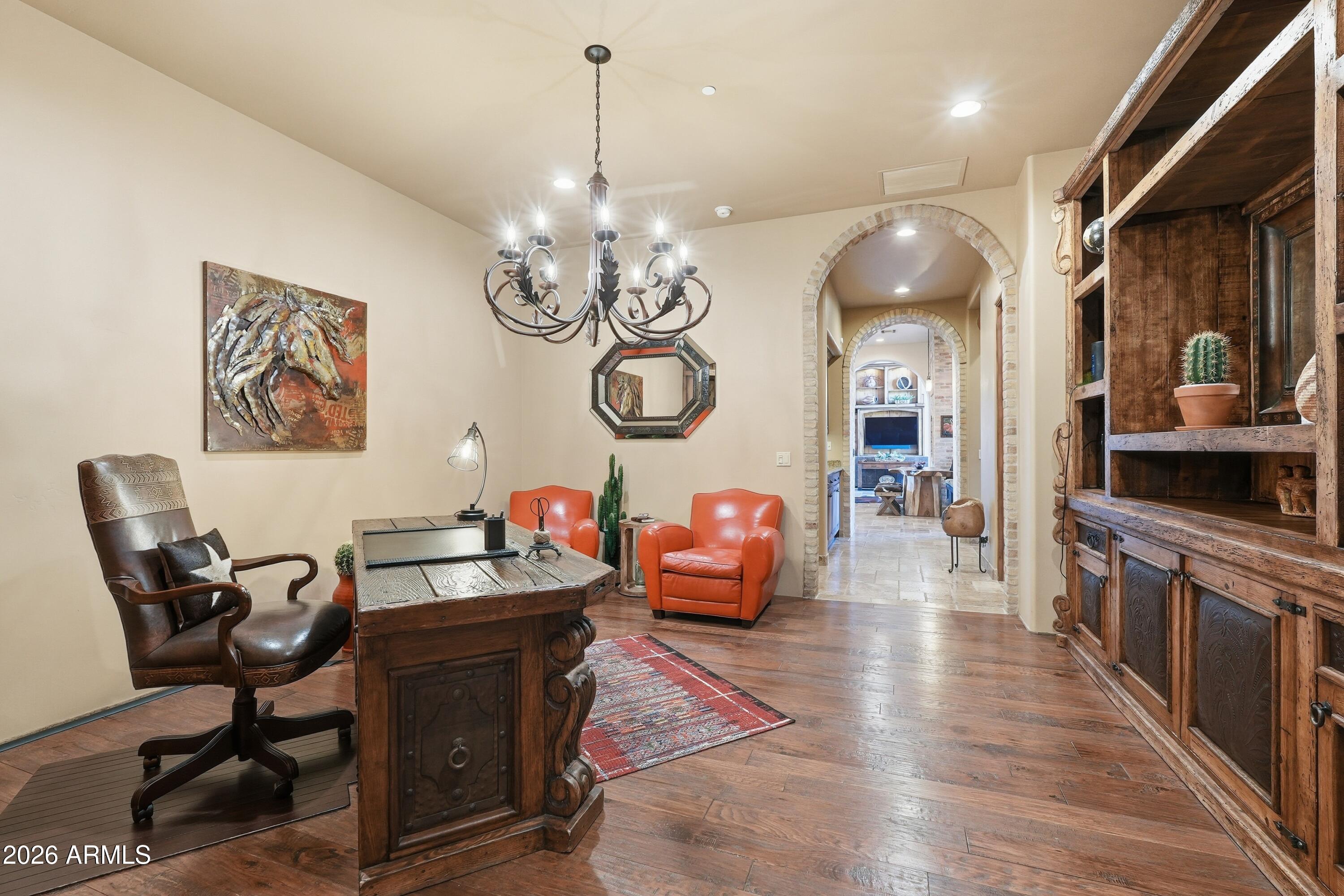 42531 North Spur Cross Road Cave Creek, AZ 85331 - Photo 16 of 75 a view of a dining room with furniture a chandelier and wooden floor