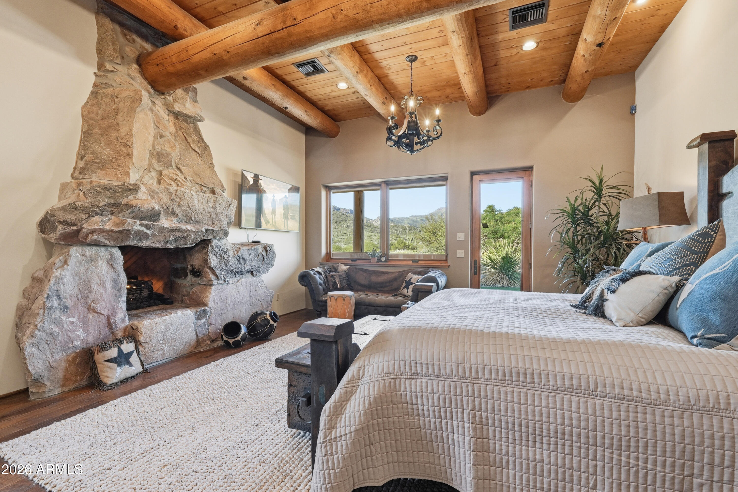 42531 North Spur Cross Road Cave Creek, AZ 85331 - Photo 21 of 75 a bed room with a bed and a fireplace