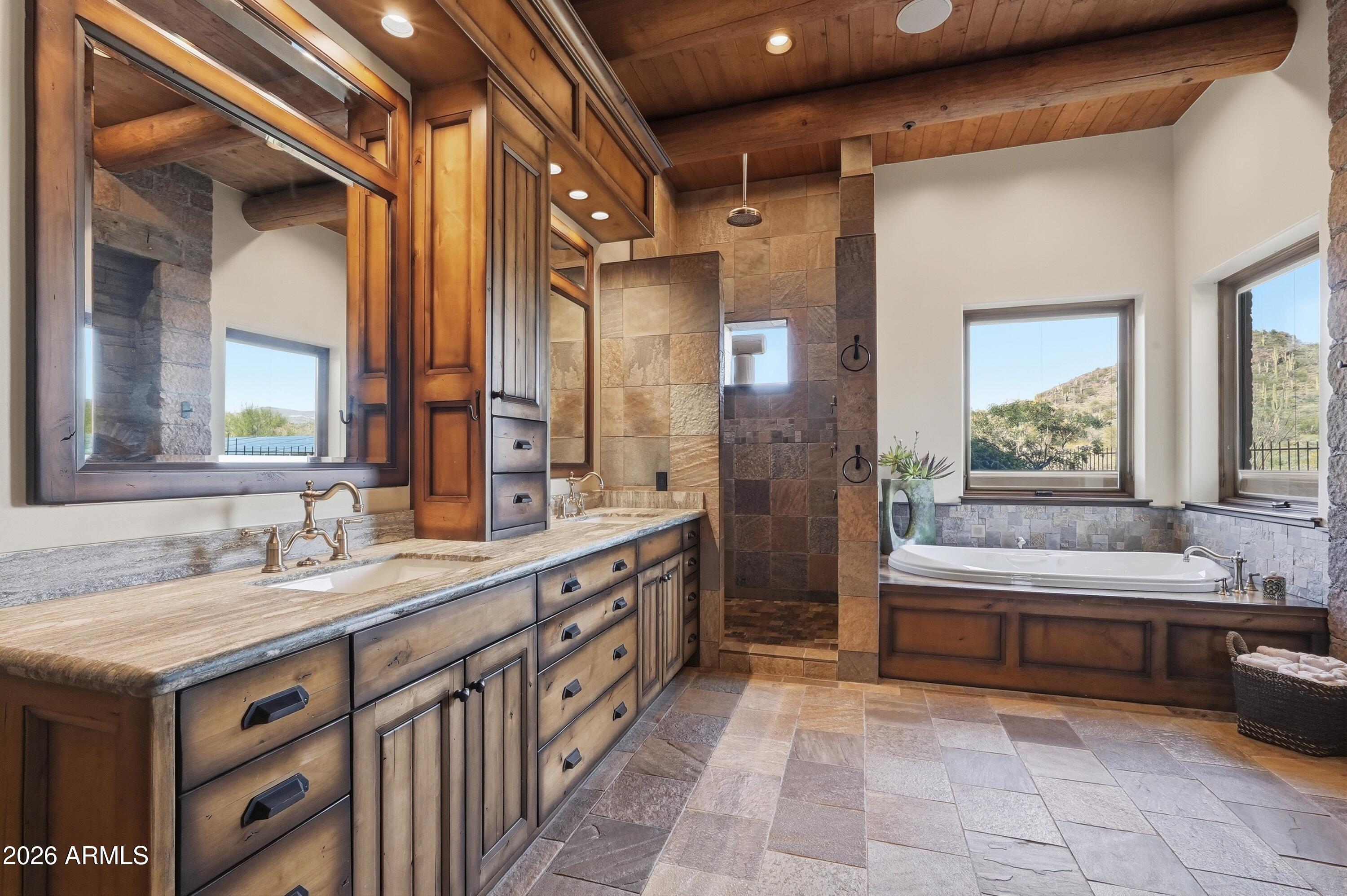 42531 North Spur Cross Road Cave Creek, AZ 85331 - Photo 22 of 75 a bathroom with a double vanity sink large mirror and a bathtub