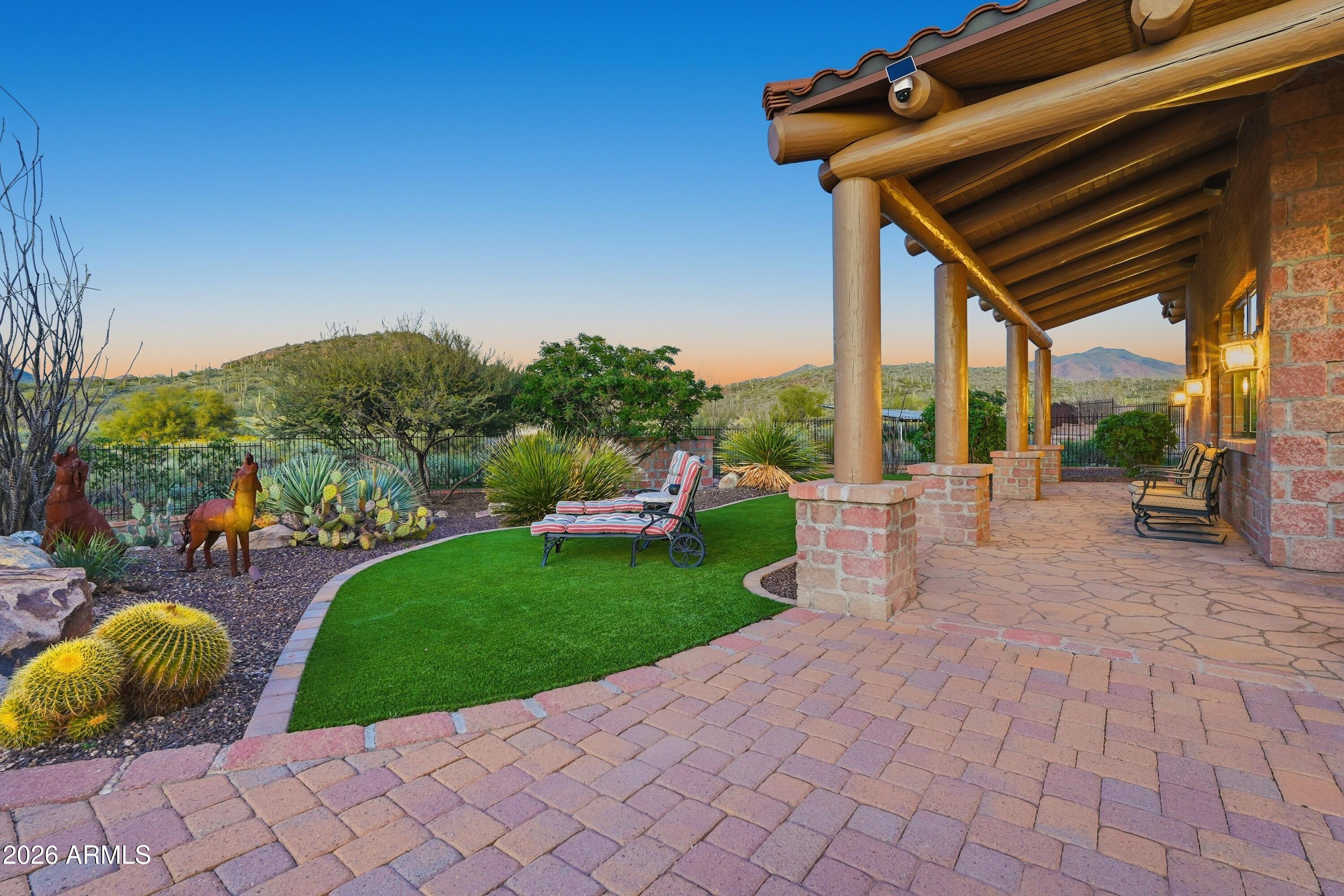 42531 North Spur Cross Road Cave Creek, AZ 85331 - Photo 33 of 75 a view of a patio with table and chairs potted plants and large tree