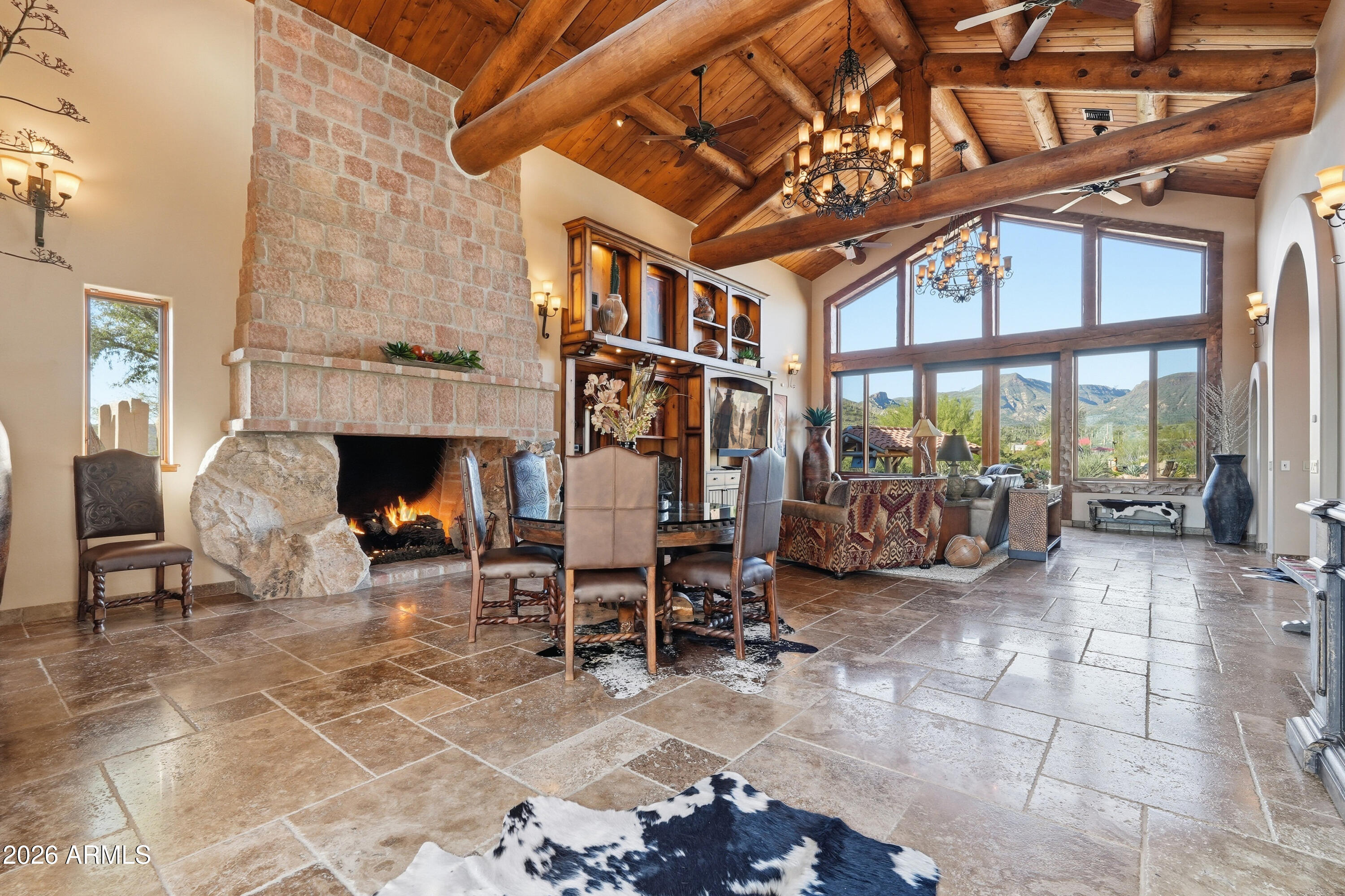 42531 North Spur Cross Road Cave Creek, AZ 85331 - Photo 4 of 75 a living room with furniture a fireplace and a floor to ceiling window