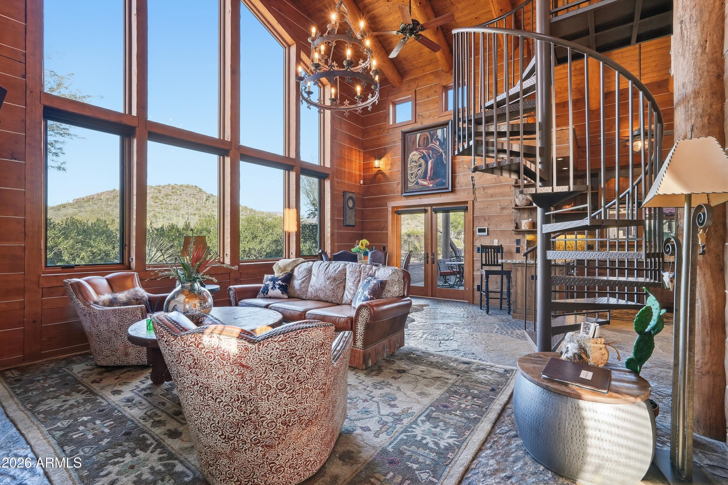 42531 North Spur Cross Road Cave Creek, AZ 85331 - Photo 46 of 75 a living room with couches a coffee table and chairs with an umbrella