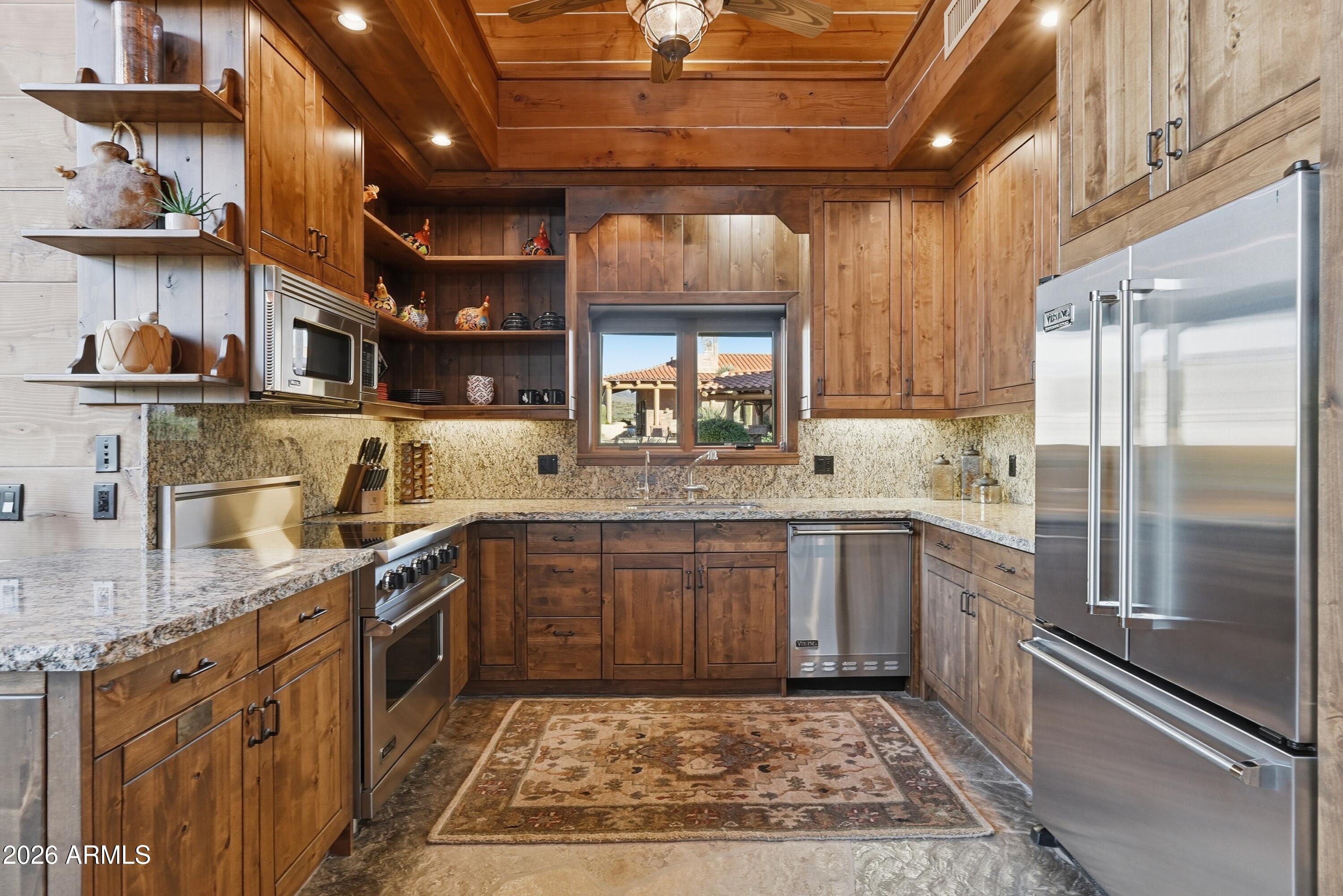 42531 North Spur Cross Road Cave Creek, AZ 85331 - Photo 51 of 75 a kitchen with stainless steel appliances granite countertop a sink stove and cabinets