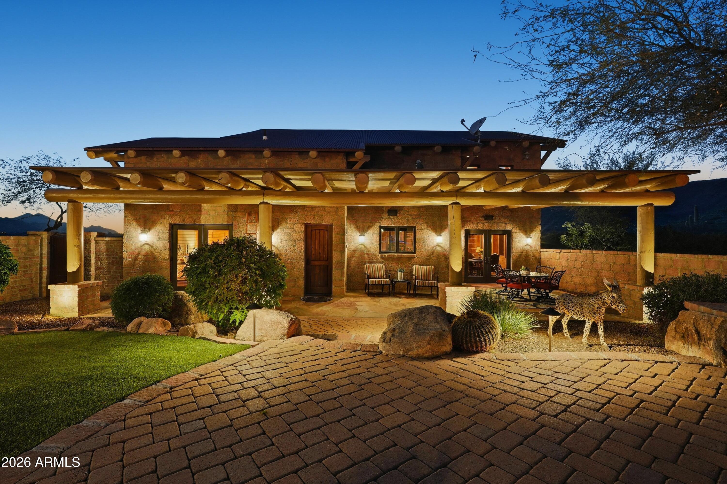 42531 North Spur Cross Road Cave Creek, AZ 85331 - Photo 56 of 75 a view of a patio with table and chairs potted plants and large tree