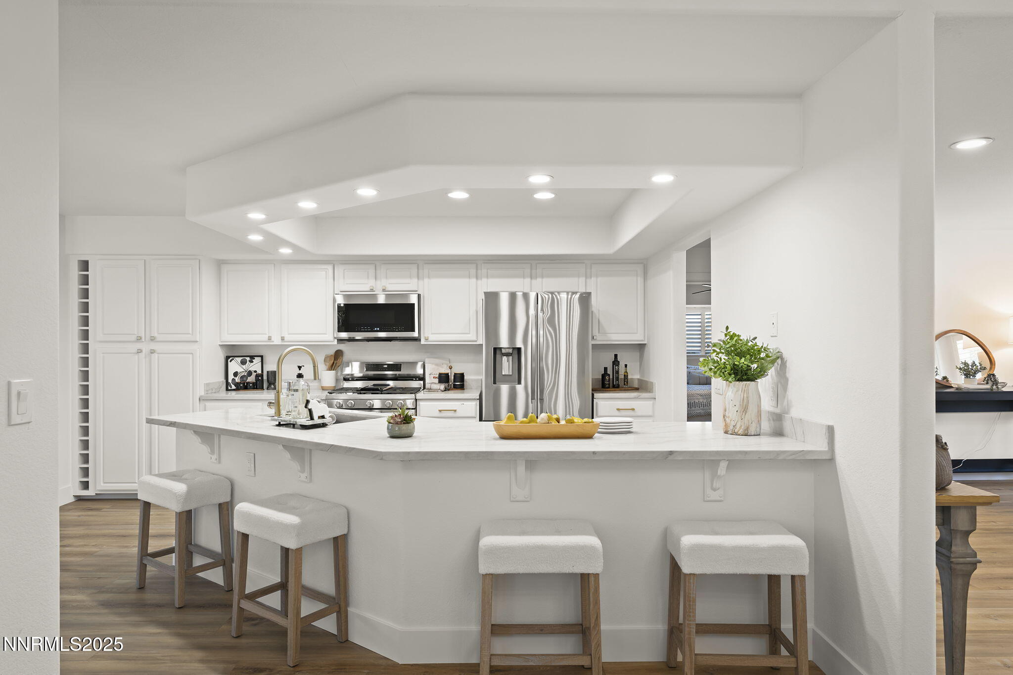 1855 Hunter Lake Drive Reno, NV 89509 - Photo 13 of 37 a kitchen with stainless steel appliances a dining table chairs refrigerator and microwave