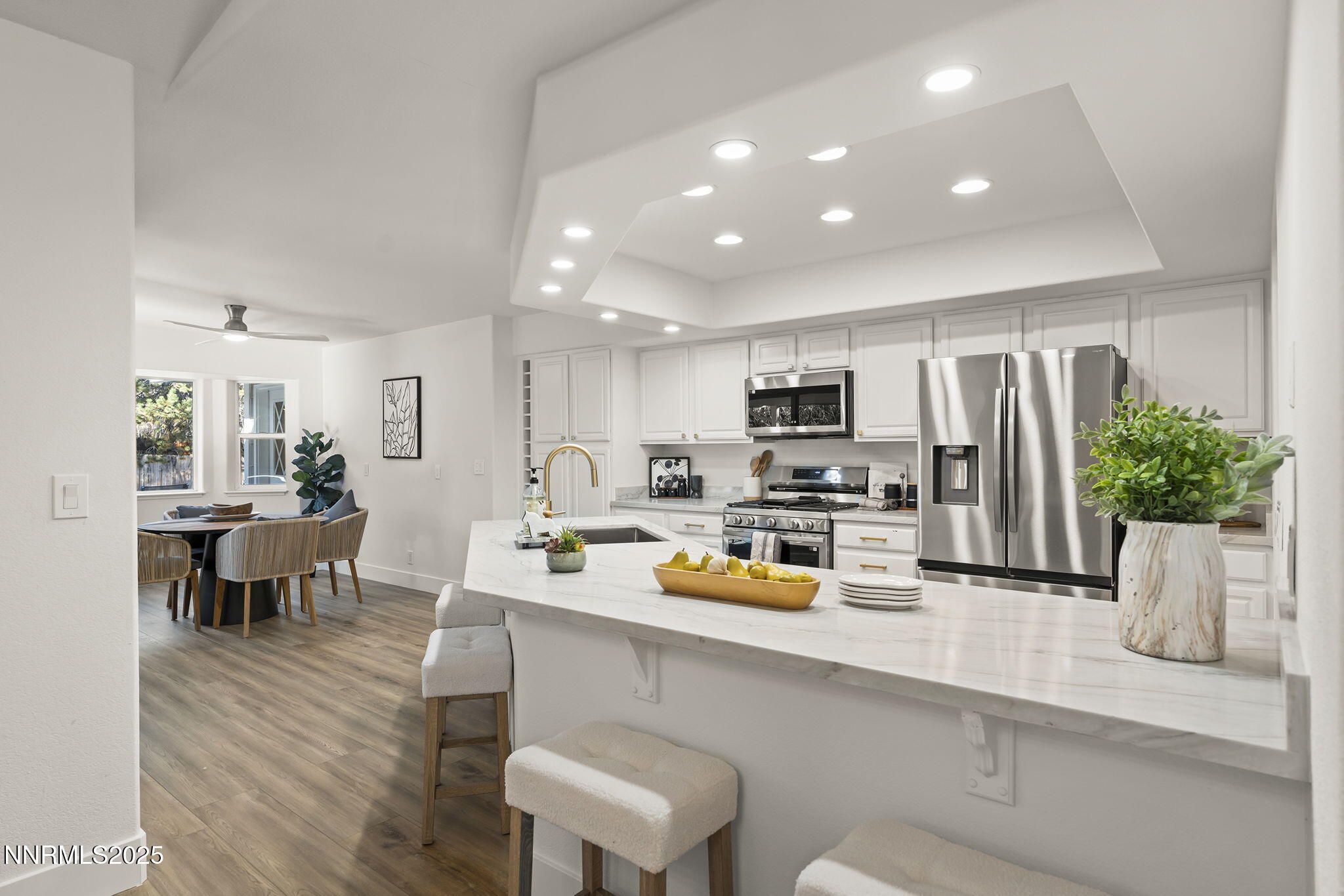 1855 Hunter Lake Drive Reno, NV 89509 - Photo 14 of 37 a kitchen with a sink a refrigerator and chairs